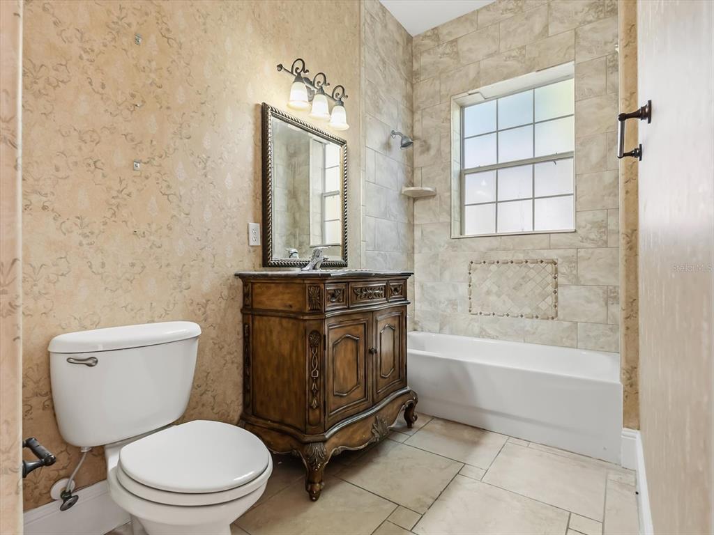 1554 Corolla Court Reunion, FL 34747 - Photo 49 of 75 a bathroom with a toilet a sink and bathtub