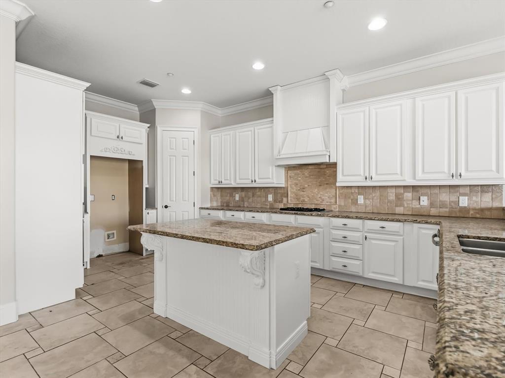 1554 Corolla Court Reunion, FL 34747 - Photo 5 of 71 a kitchen with stainless steel appliances granite countertop a stove a sink and a refrigerator