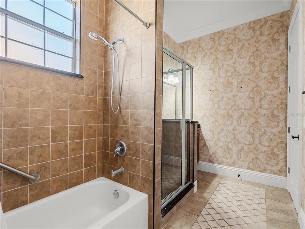 1554 Corolla Court Reunion, FL 34747 - Photo 54 of 75 a bathroom with a bathtub and shower