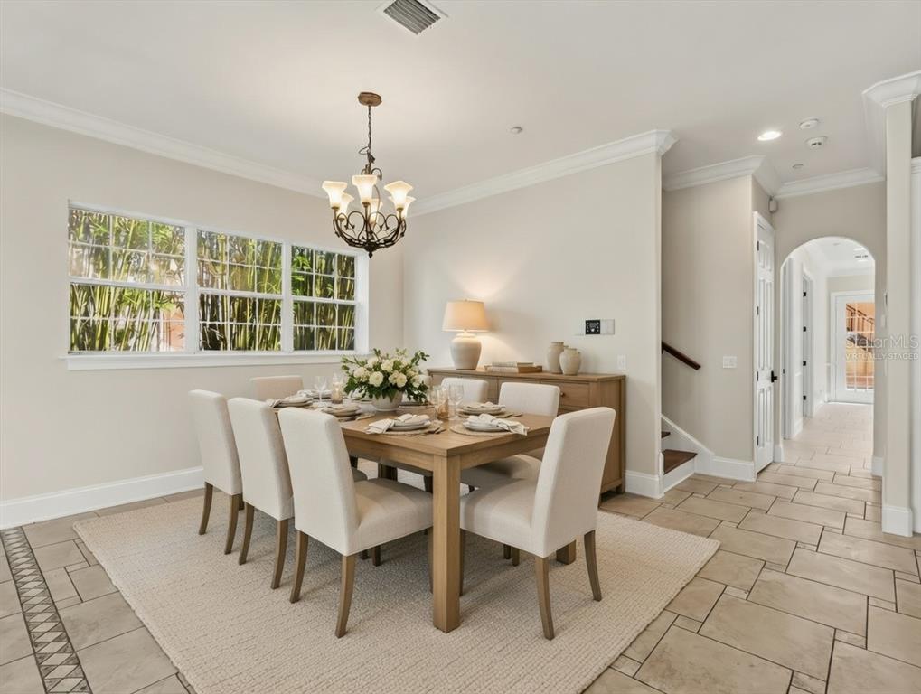 1554 Corolla Court Reunion, FL 34747 - Photo 7 of 75 a view of a dining room with furniture and chandelier