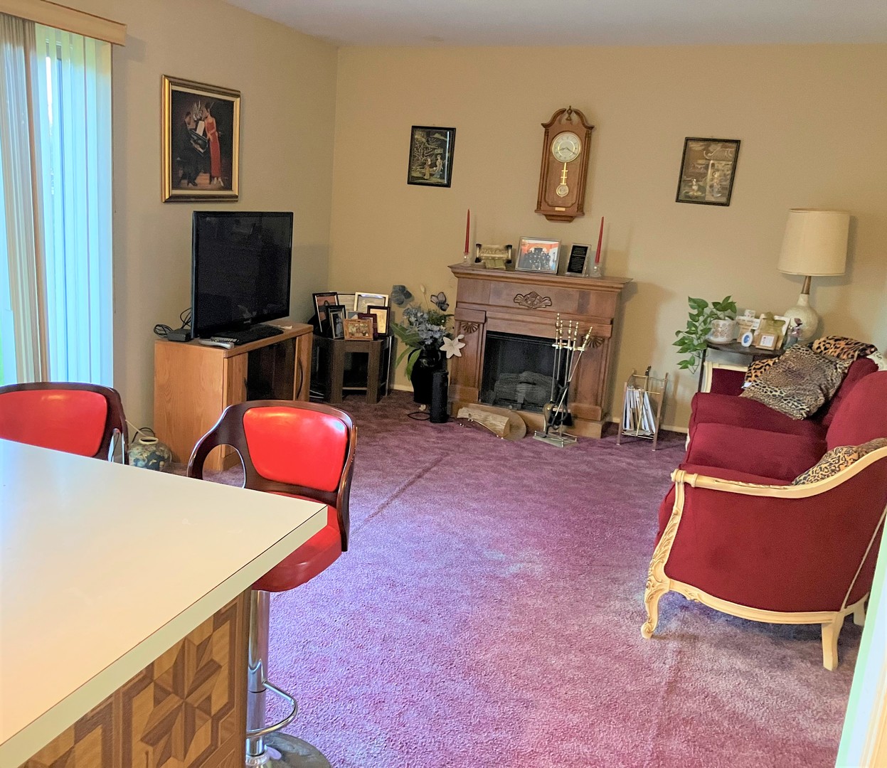 46 Wedgewood Road Matteson, IL 60443 - Photo 4 of 7 a living room with furniture a flat screen tv and a fireplace