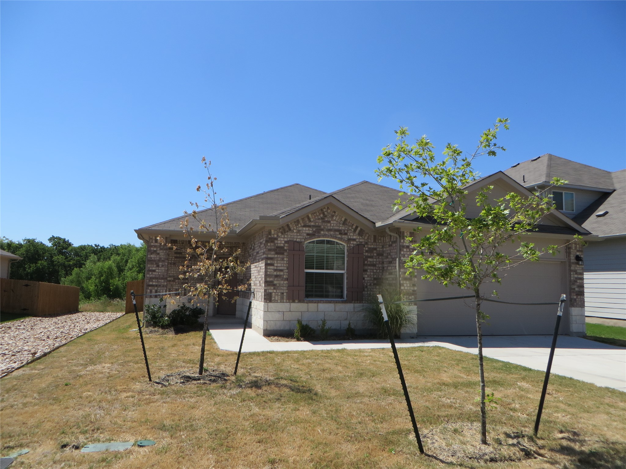 6201 Kildare Drive Georgetown, TX 78626 - Photo 1 of 29 Ranch-style home with brick siding, a garage, concrete driveway, and a front yard