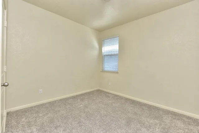 an empty room with a empty space and windows