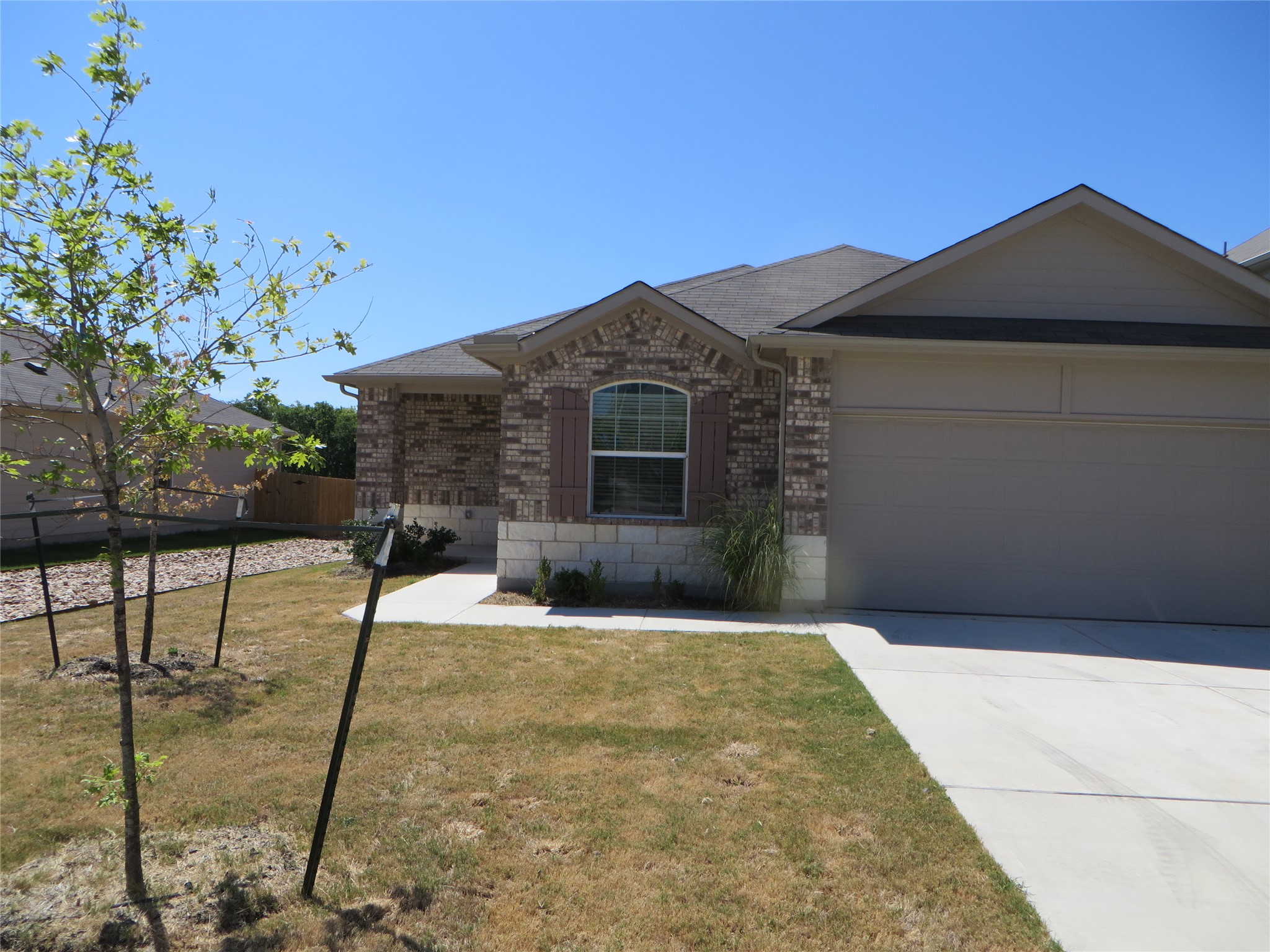 6201 Kildare Drive Georgetown, TX 78626 - Photo 2 of 29 Ranch-style house with brick siding, a front yard, concrete driveway, and an attached garage