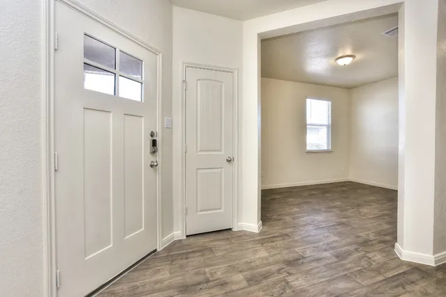 an empty room with windows and closet