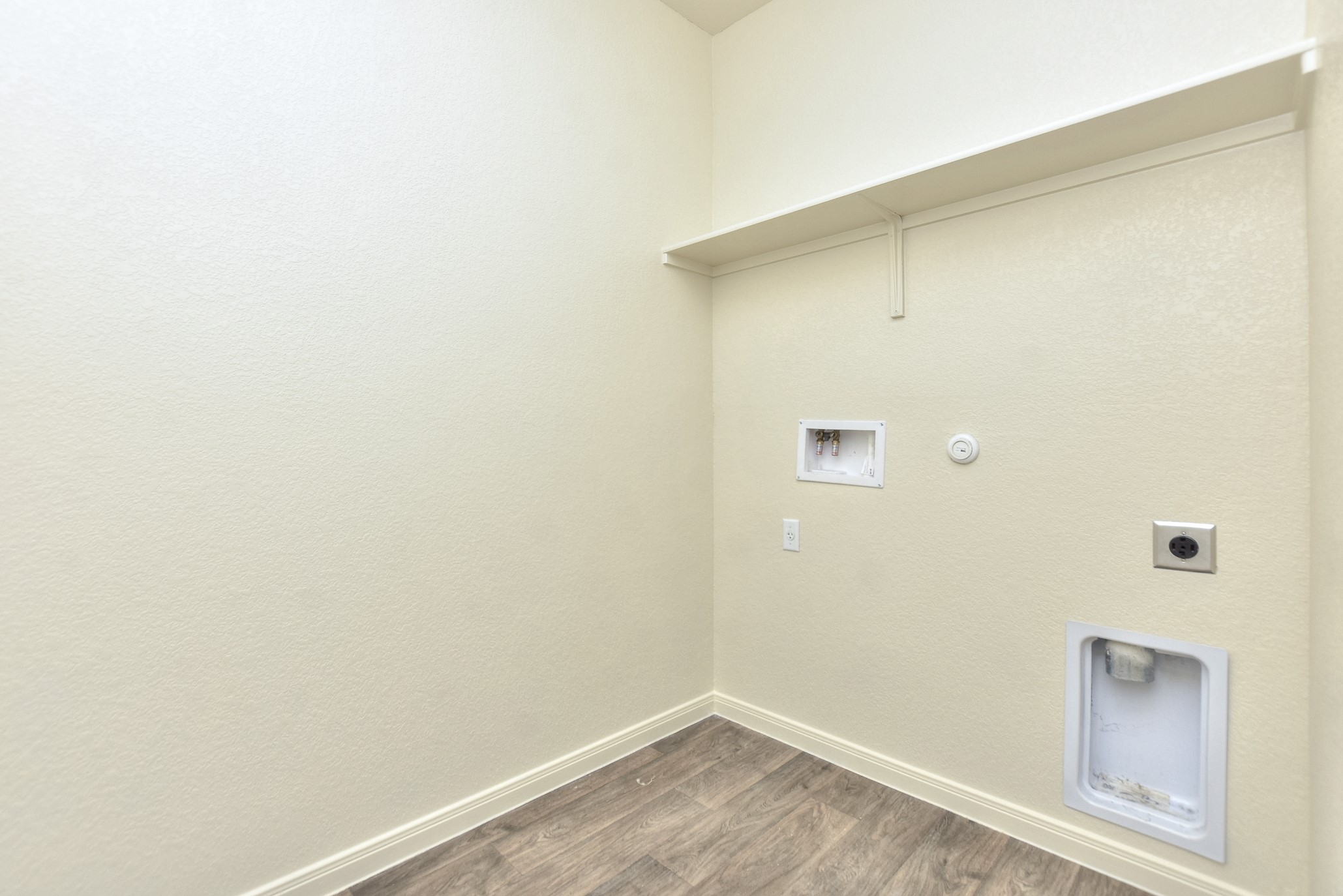 6201 Kildare Drive Georgetown, TX 78626 - Photo 10 of 29 Laundry area featuring washer hookup, dark wood-style flooring, electric dryer hookup, laundry area, and hookup for a gas dryer