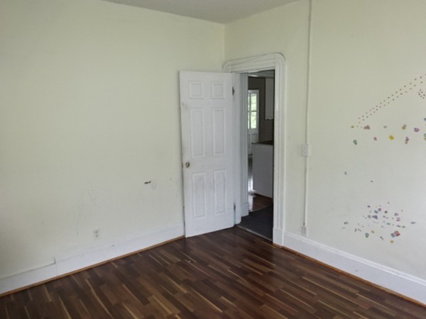 256 White Street Springfield, MA 01108 - Photo 11 of 15 an empty room with wooden floor