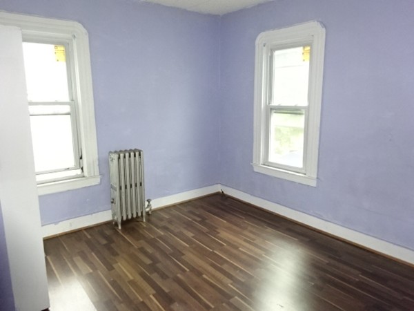 256 White Street Springfield, MA 01108 - Photo 13 of 15 a view of empty room with wooden floor and fan