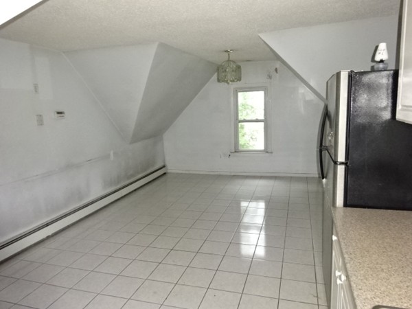 256 White Street Springfield, MA 01108 - Photo 15 of 15 an empty room with windows and refrigerator
