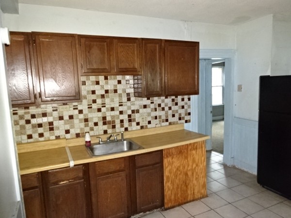 256 White Street Springfield, MA 01108 - Photo 2 of 15 a kitchen with a sink a stove and refrigerator