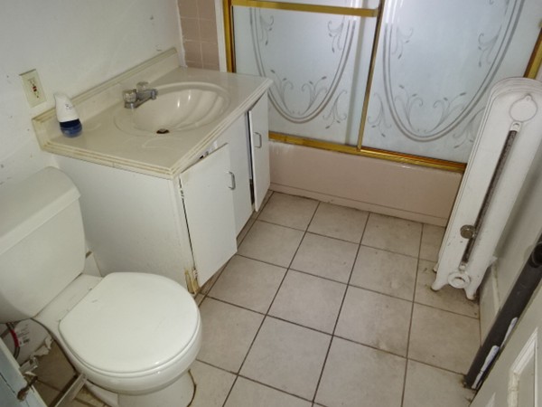 256 White Street Springfield, MA 01108 - Photo 6 of 15 a bathroom with a sink a toilet and a mirror