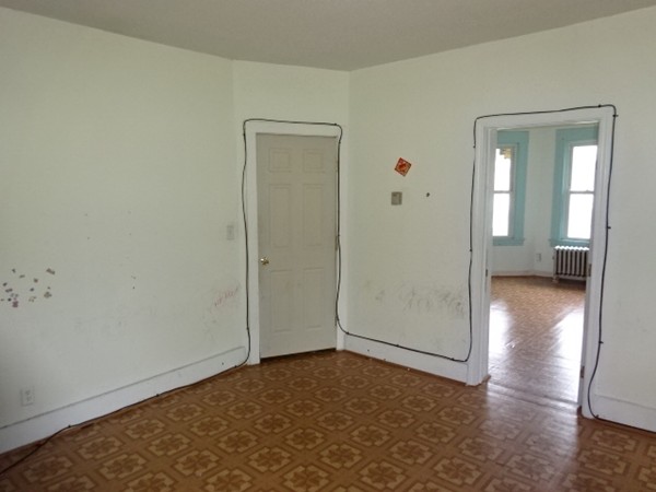 256 White Street Springfield, MA 01108 - Photo 9 of 15 an empty room with wooden floor and a window