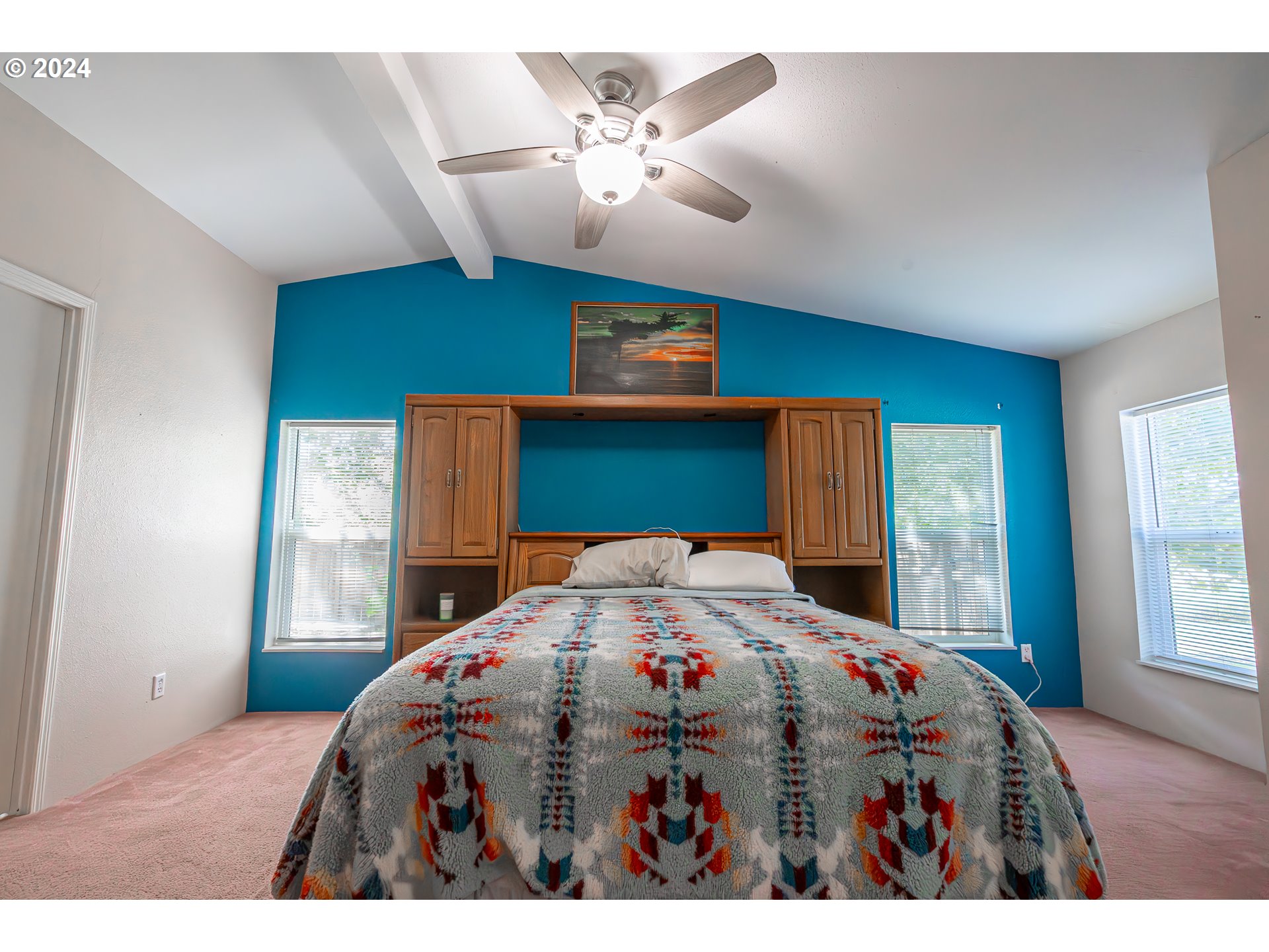 710 North Howe Street Carlton, OR 97111 - Photo 12 of 31 a bedroom with a bed a chandelier and a window