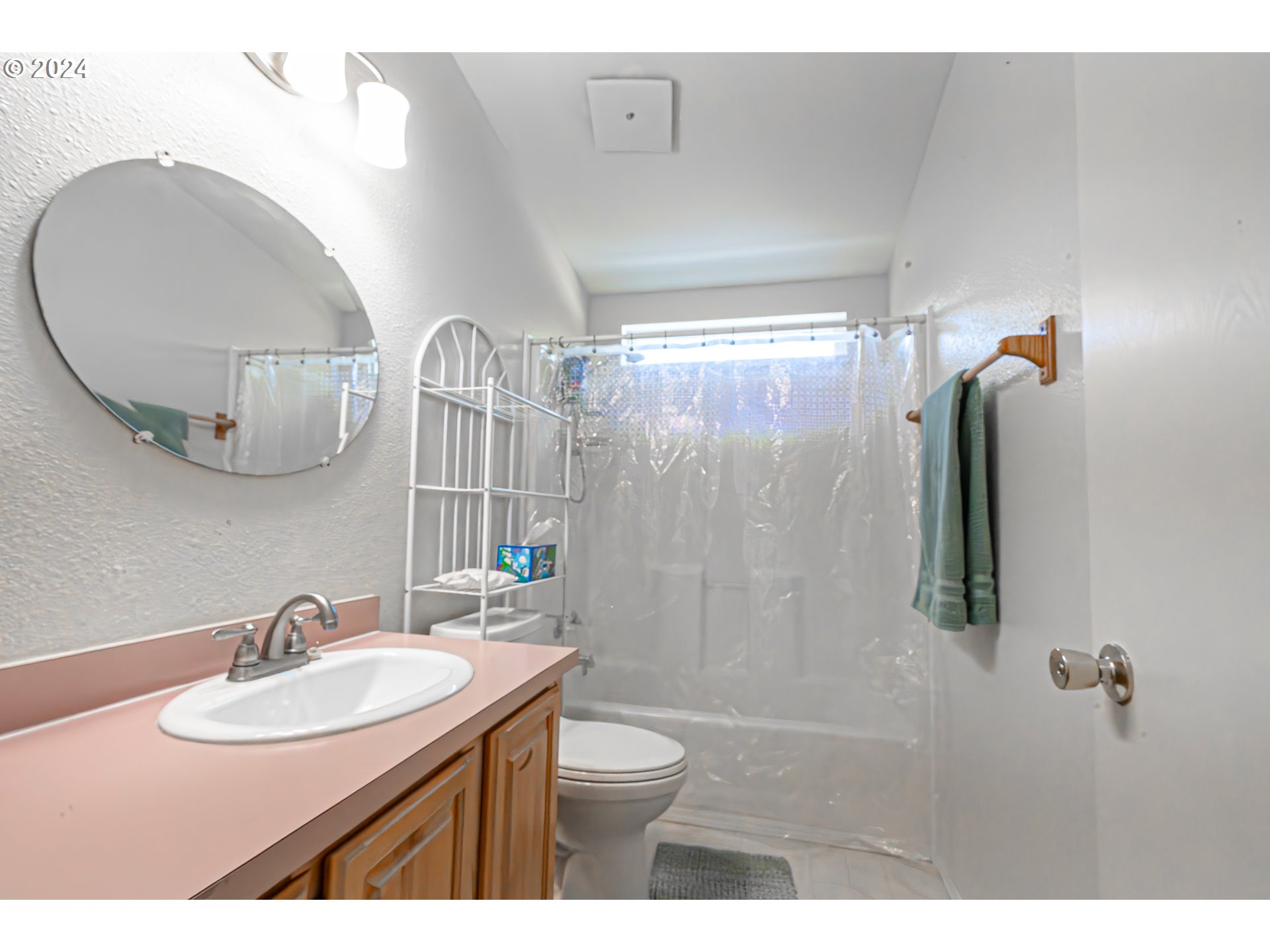710 North Howe Street Carlton, OR 97111 - Photo 17 of 31 a bathroom with a granite countertop sink a toilet a mirror and shower