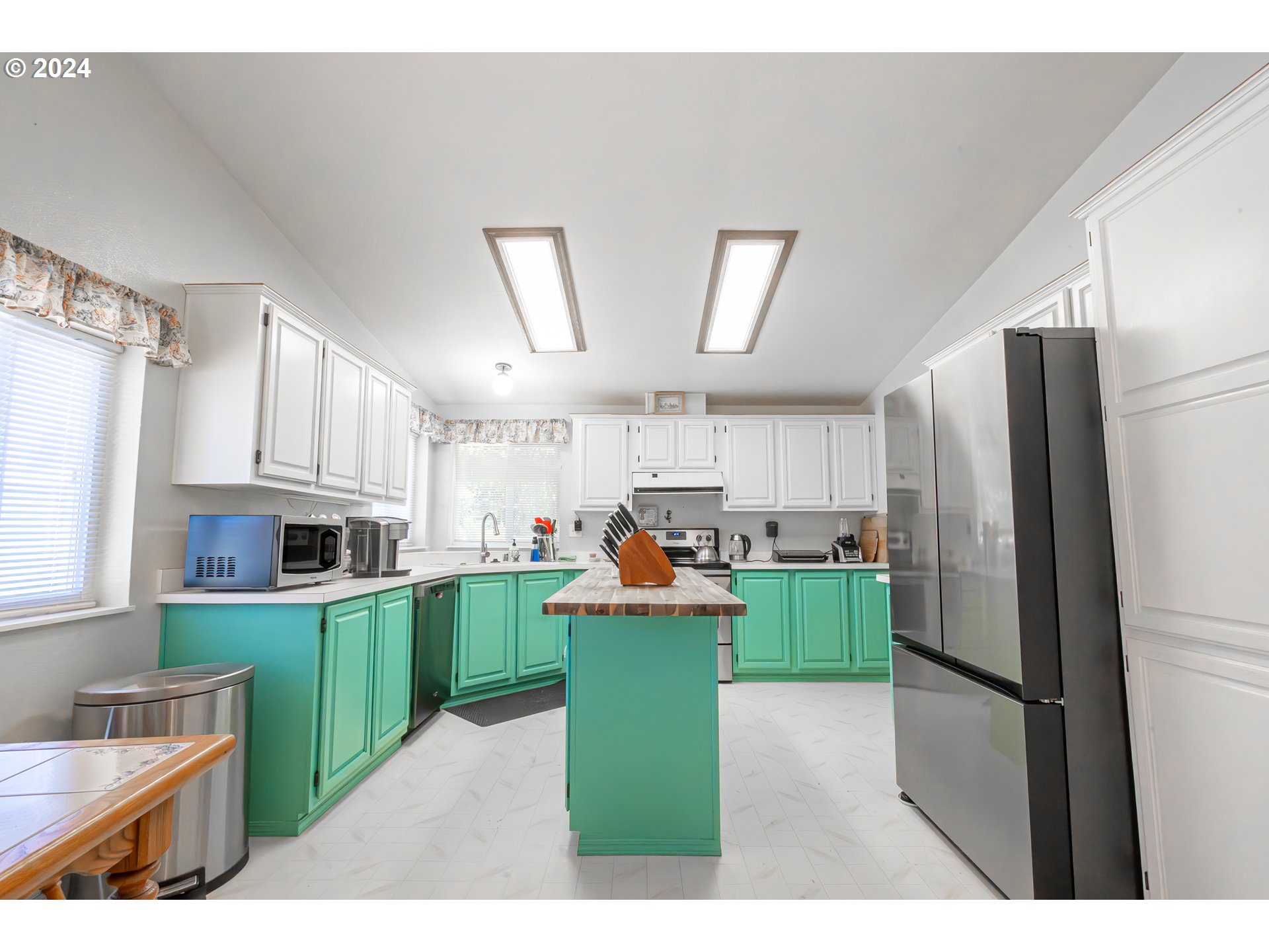 710 North Howe Street Carlton, OR 97111 - Photo 6 of 31 a kitchen with cabinets and wooden floors