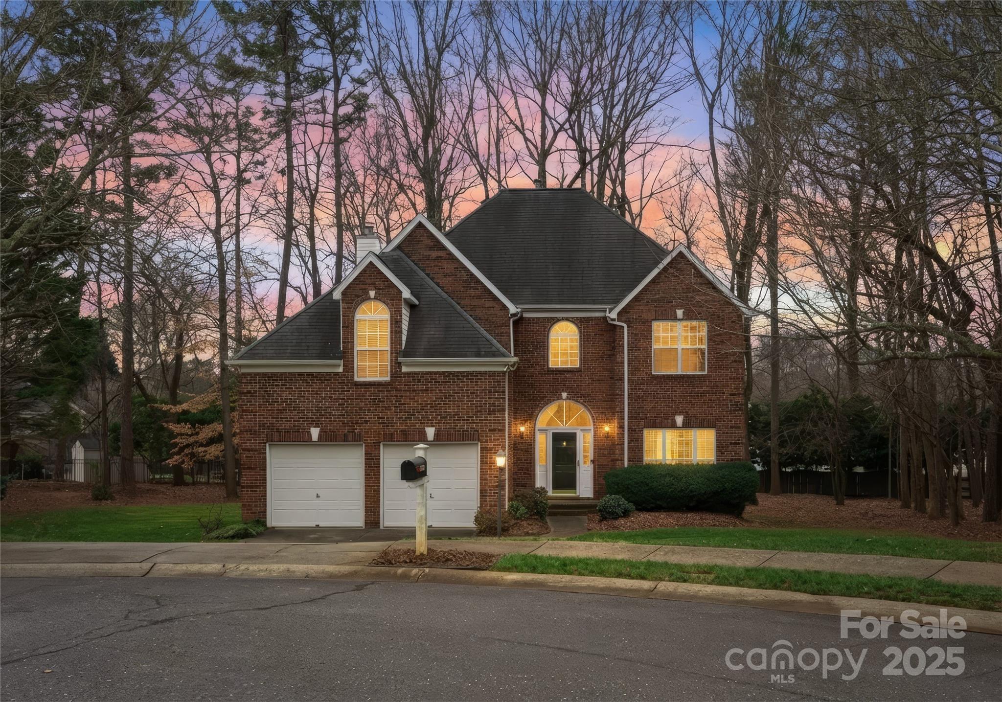 1736 Walnut Crest Lane Matthews, NC 28105 - Photo 2 of 41 a front view of a house with a yard and garage