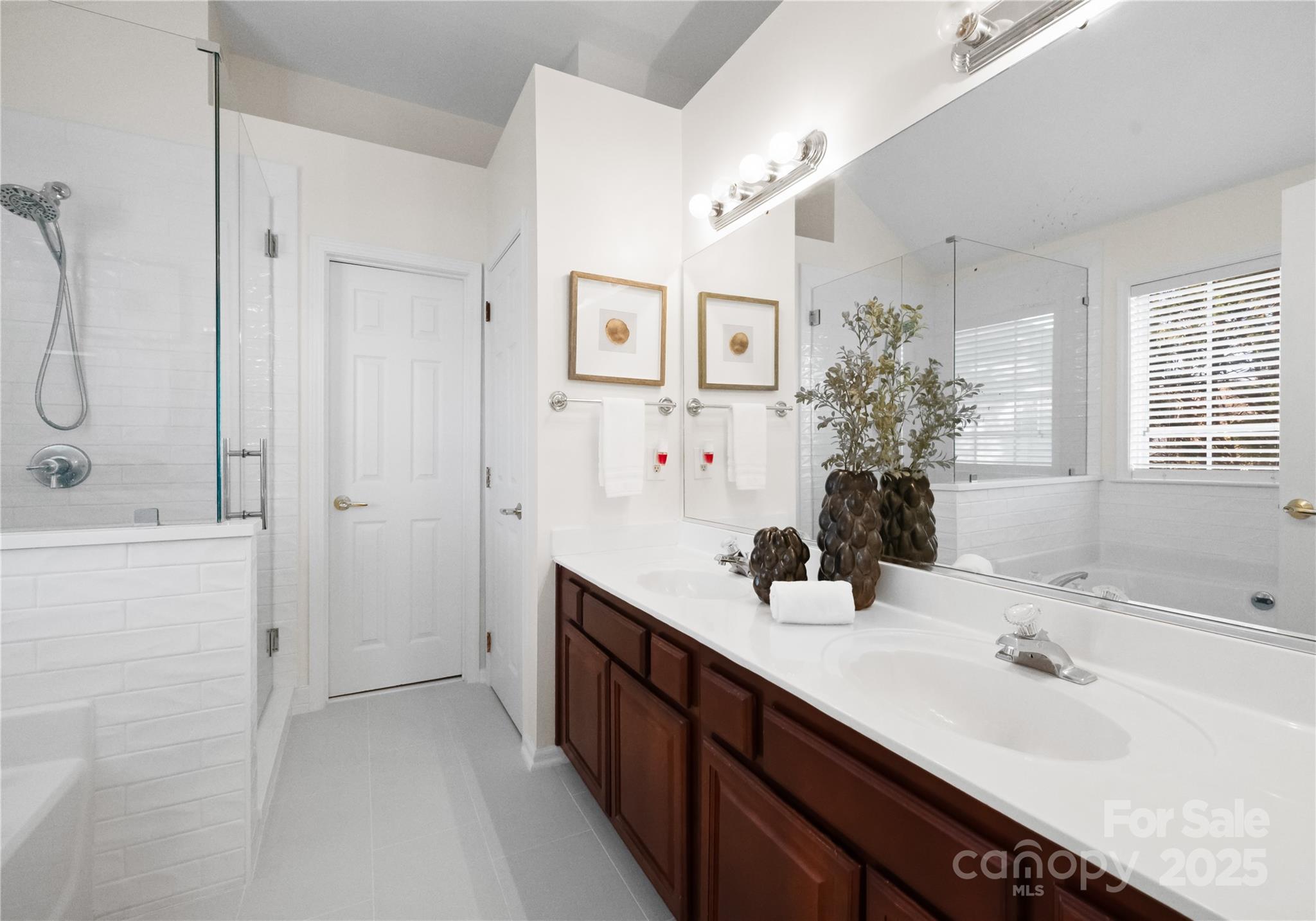 1736 Walnut Crest Lane Matthews, NC 28105 - Photo 29 of 41 a bathroom with a double vanity sink mirror and shower