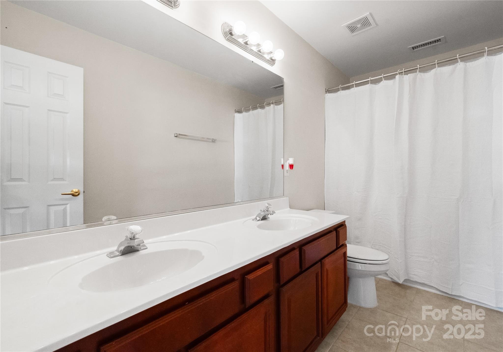 1736 Walnut Crest Lane Matthews, NC 28105 - Photo 33 of 41 a bathroom with a sink and a mirror
