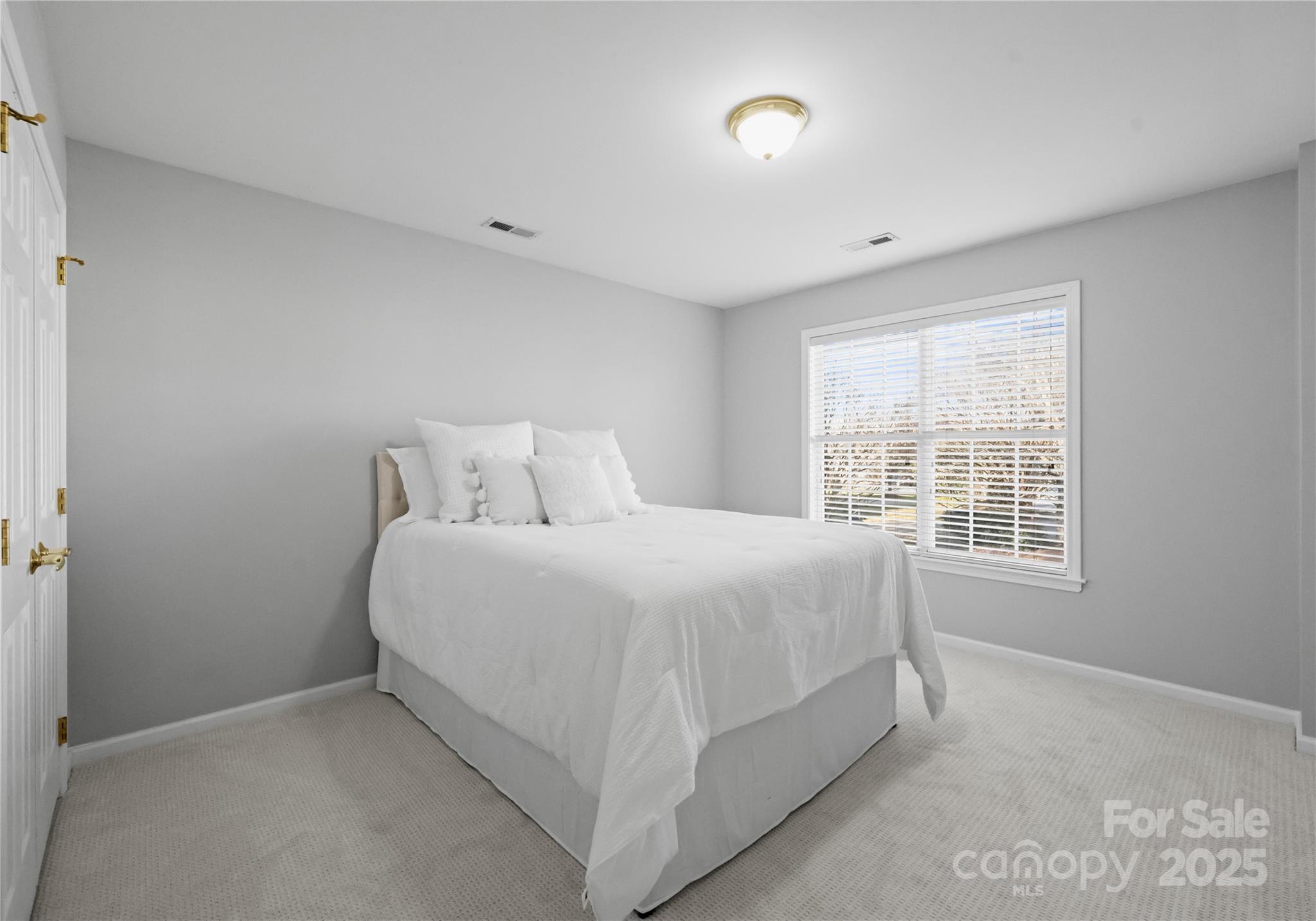 1736 Walnut Crest Lane Matthews, NC 28105 - Photo 35 of 41 a spacious bedroom with a bed and a window