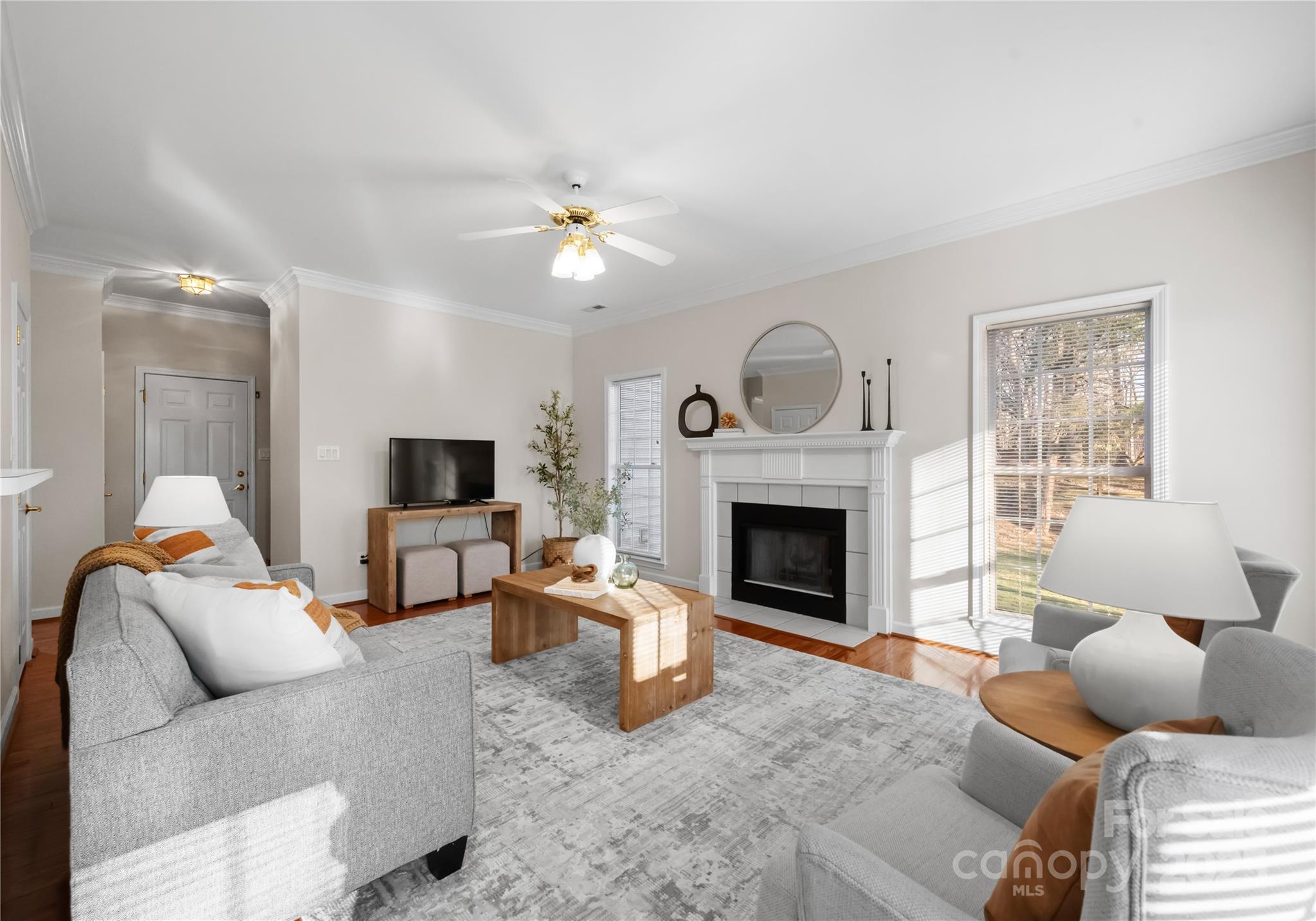 1736 Walnut Crest Lane Matthews, NC 28105 - Photo 7 of 41 a living room with furniture a fireplace and a flat screen tv