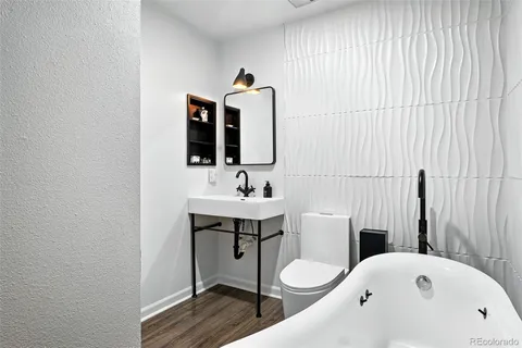 a bathroom with a toilet sink and mirror