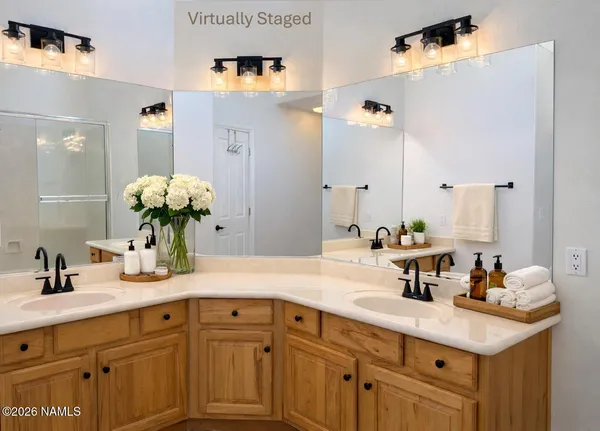 a bathroom with a sink double vanity and mirror