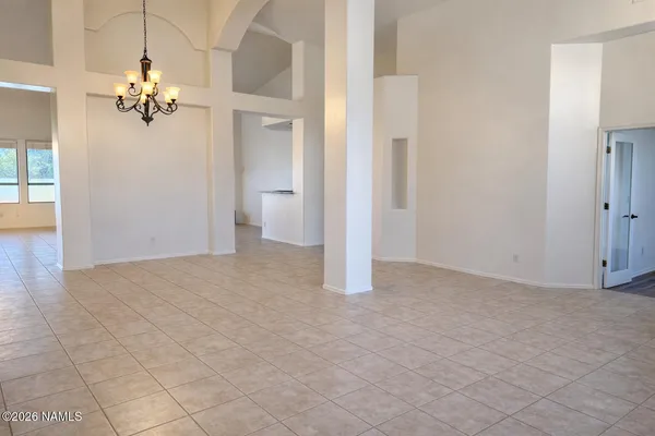a view of a chandelier fan and refrigerator in a room