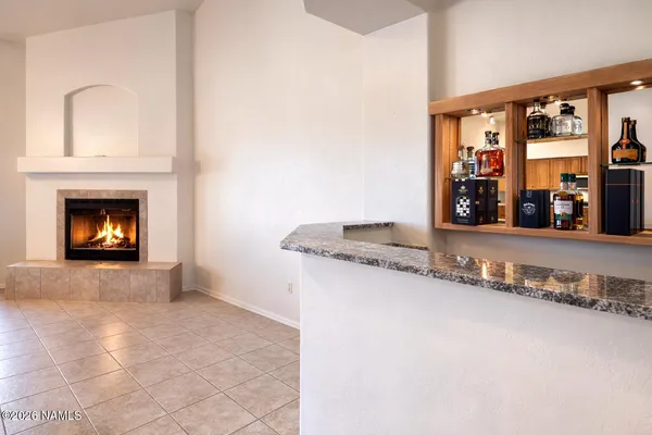 a living room with granite countertop a couch and a fireplace