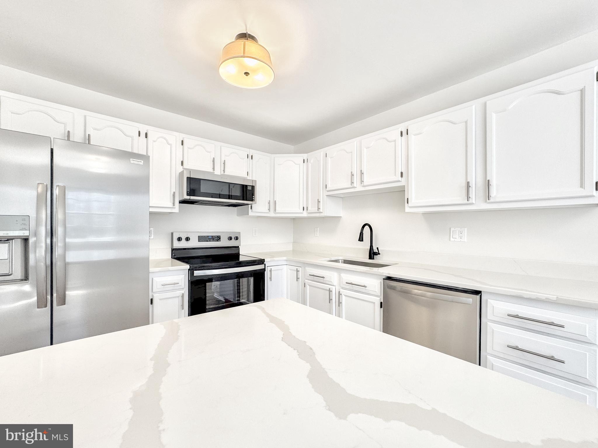 640 Santa Fe Trail Lusby, MD 20657 - Photo 11 of 32 a kitchen with stainless steel appliances granite countertop a refrigerator stove microwave and sink