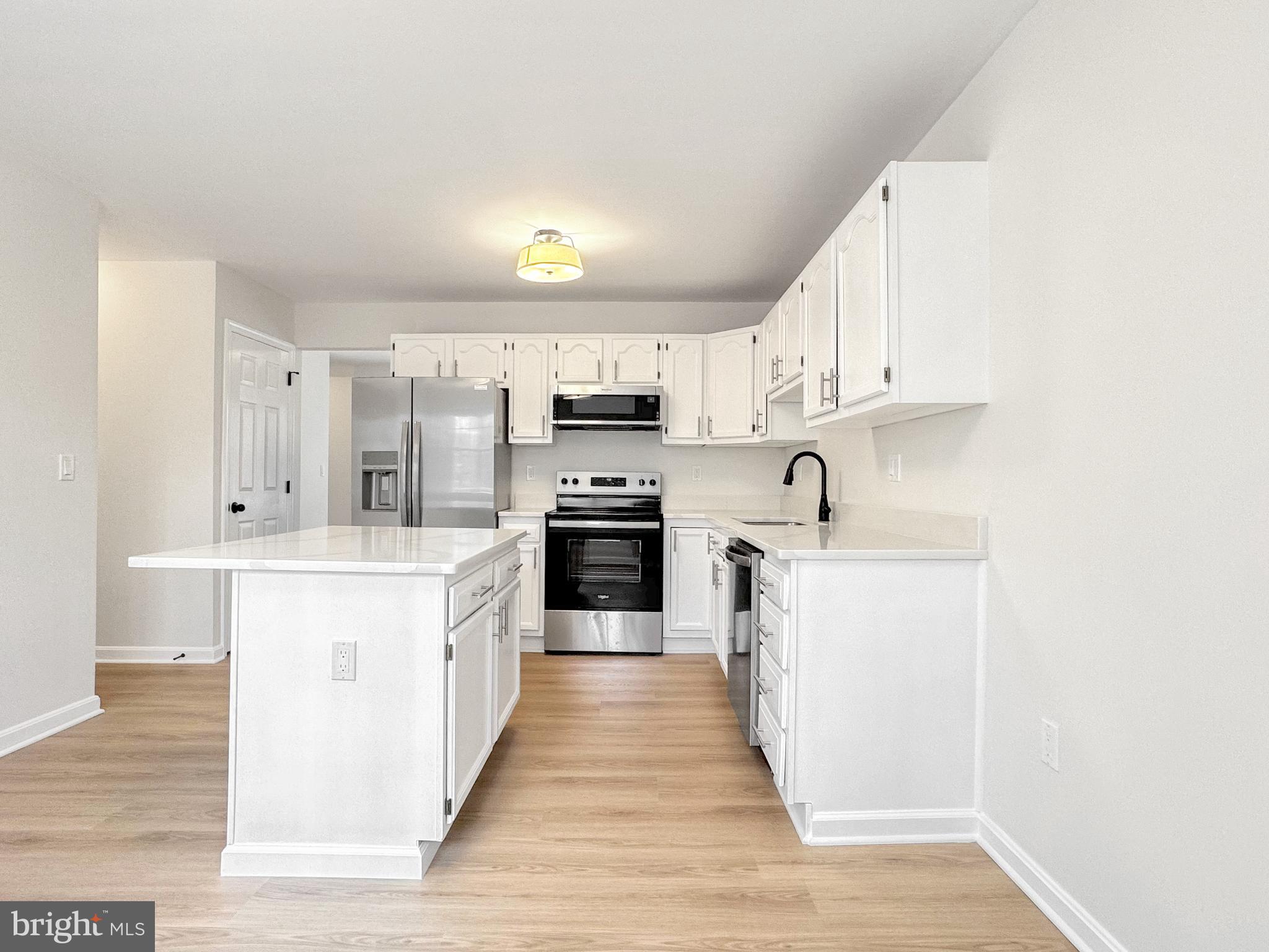 640 Santa Fe Trail Lusby, MD 20657 - Photo 14 of 32 a kitchen with stainless steel appliances granite countertop a stove top oven a sink and white cabinets