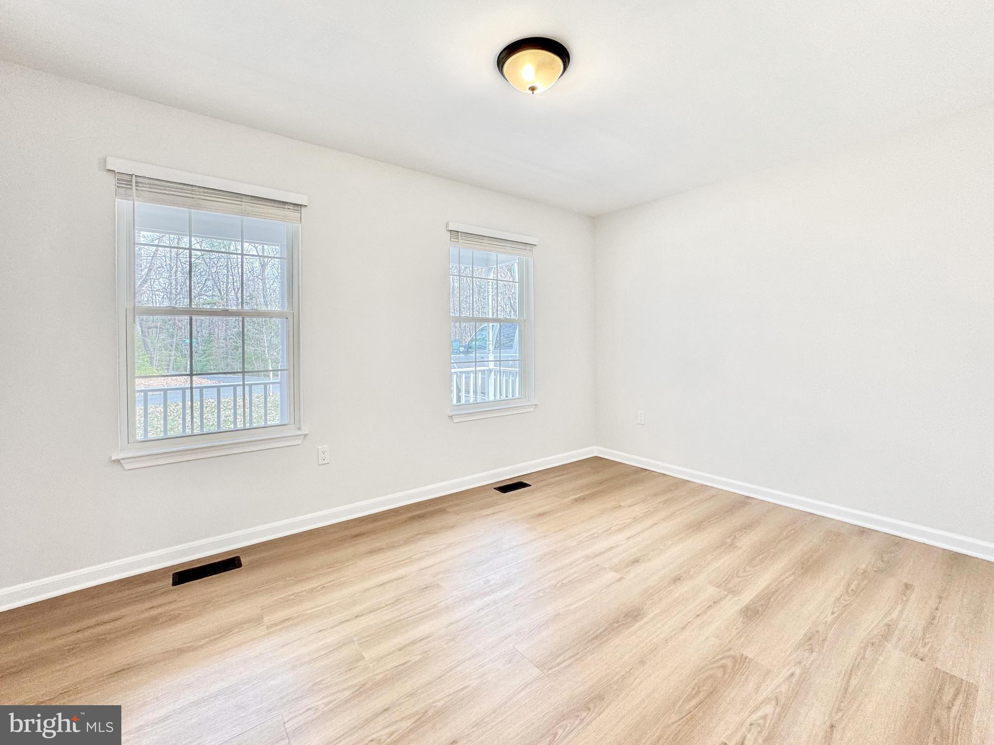 640 Santa Fe Trail Lusby, MD 20657 - Photo 15 of 32 an empty room with wooden floor and windows