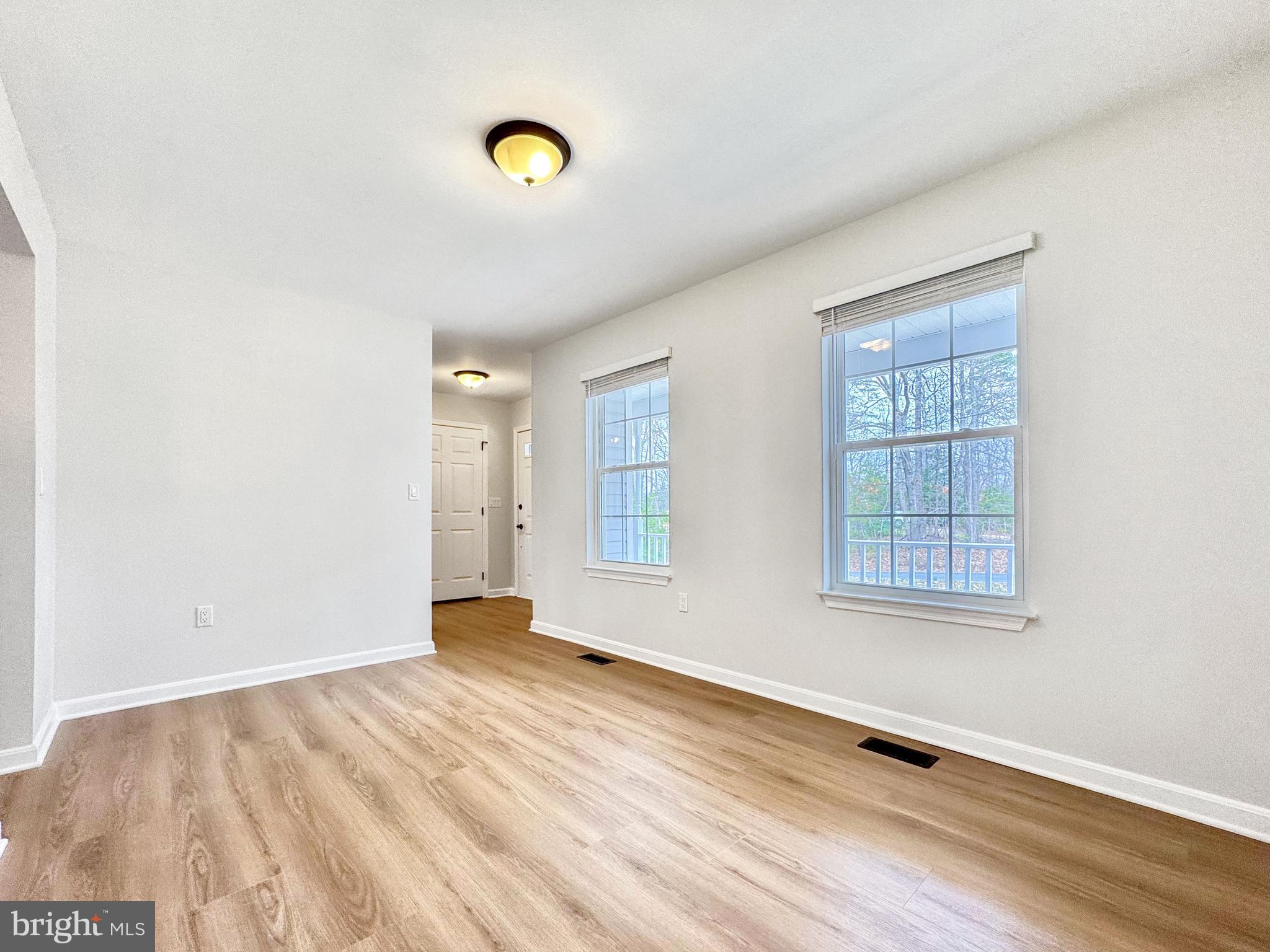 640 Santa Fe Trail Lusby, MD 20657 - Photo 16 of 32 an empty room with wooden floor and windows