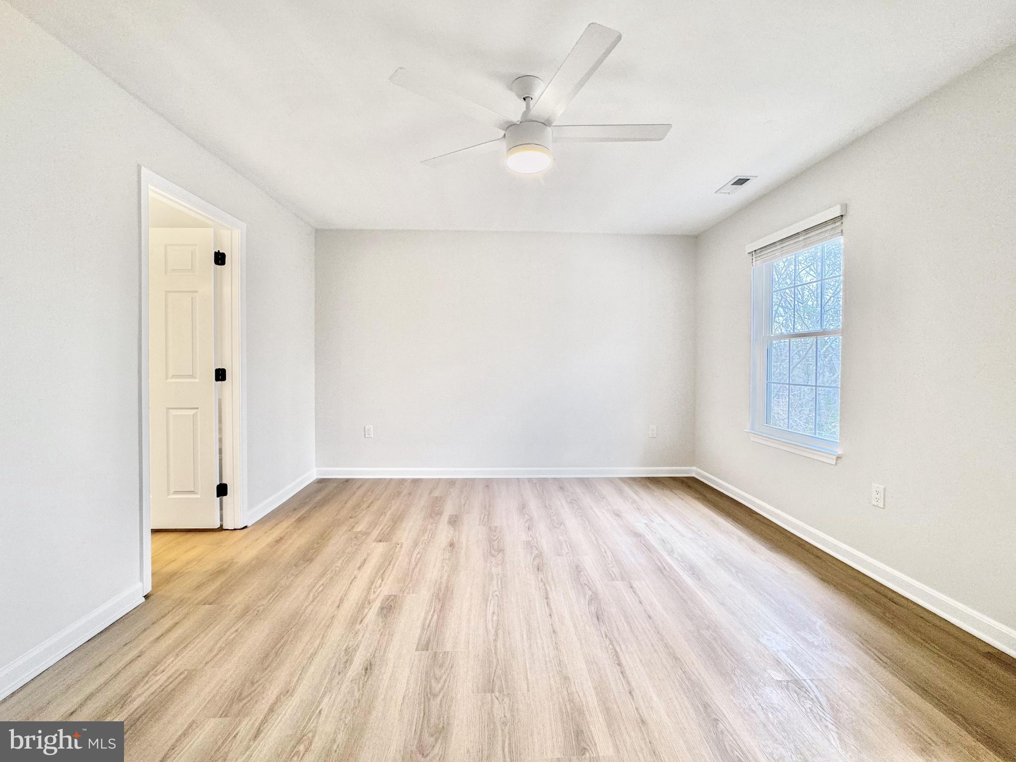 640 Santa Fe Trail Lusby, MD 20657 - Photo 19 of 32 an empty room with wooden floor and windows