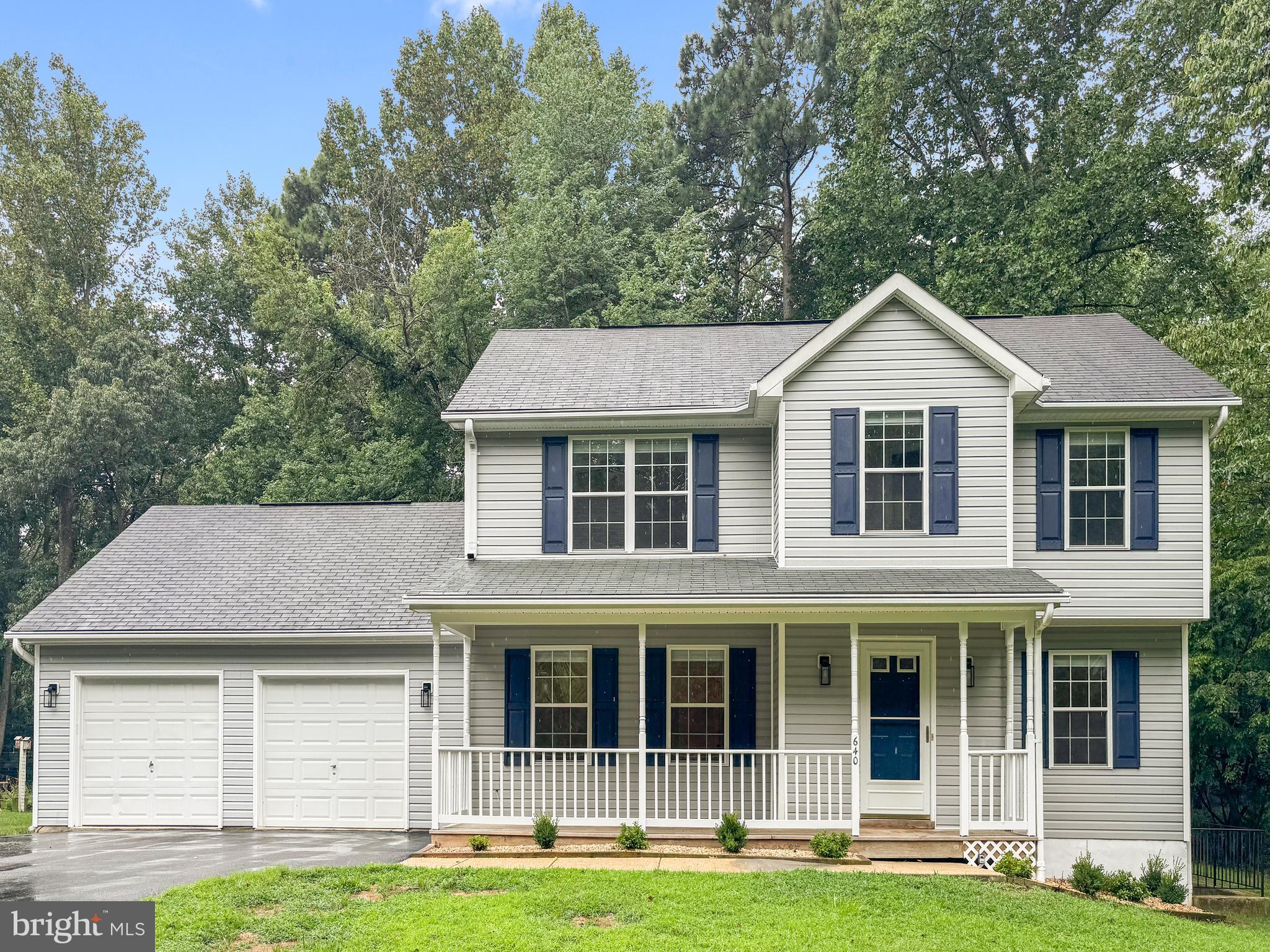 640 Santa Fe Trail Lusby, MD 20657 - Photo 2 of 32 a front view of a house with a yard and trees