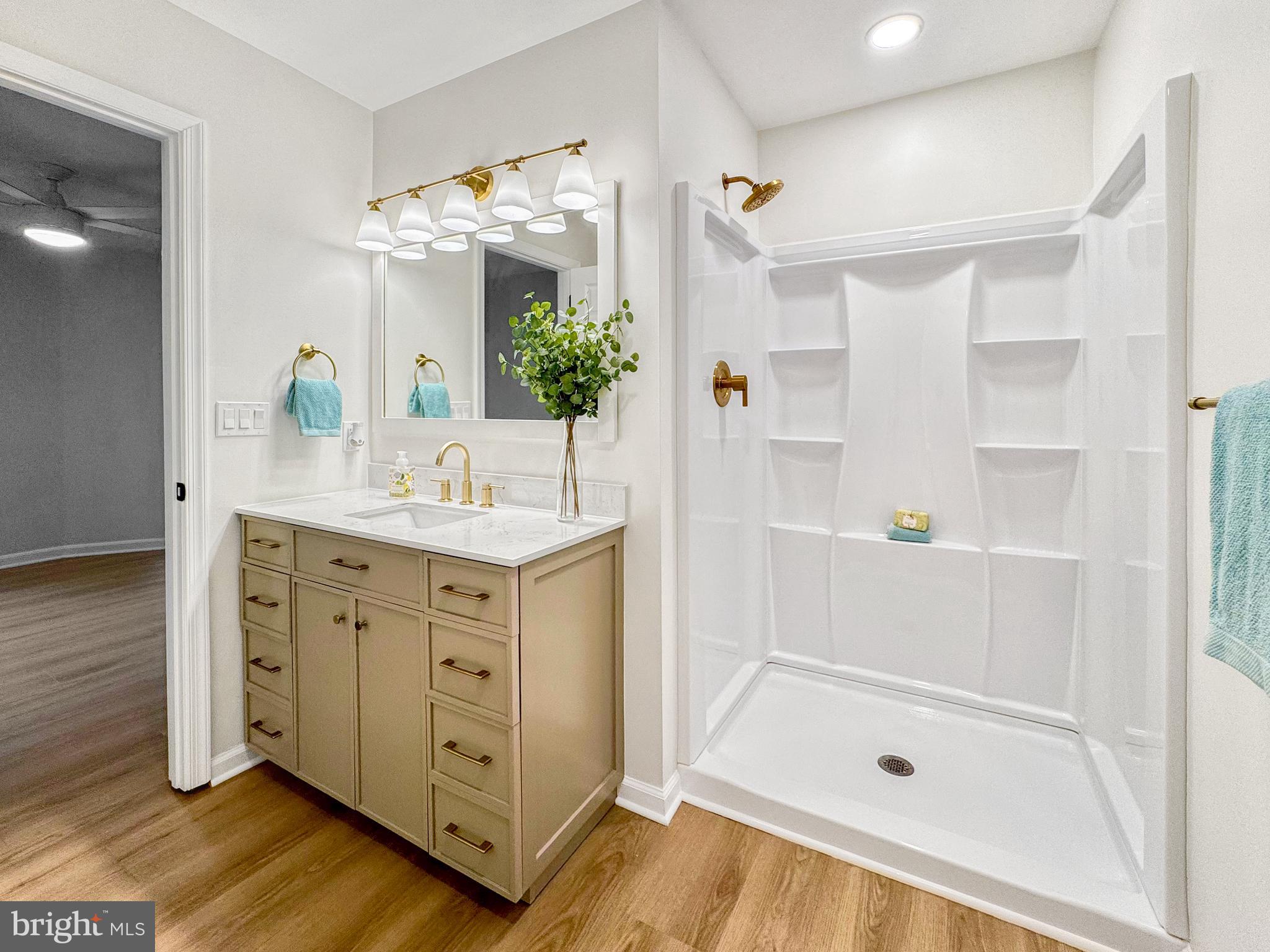 640 Santa Fe Trail Lusby, MD 20657 - Photo 22 of 32 a bathroom with a shower sink and mirror