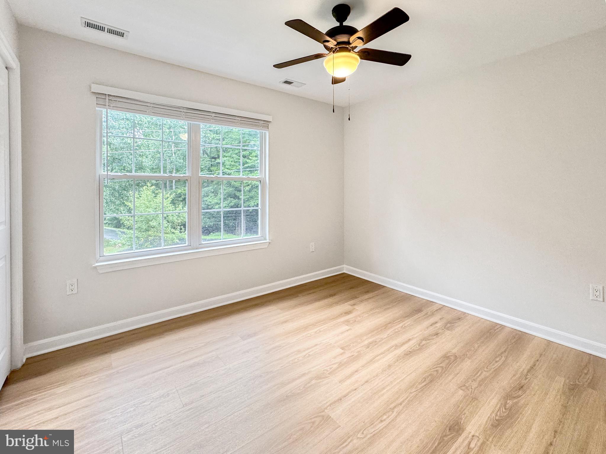 640 Santa Fe Trail Lusby, MD 20657 - Photo 23 of 32 an empty room with a window and a fan