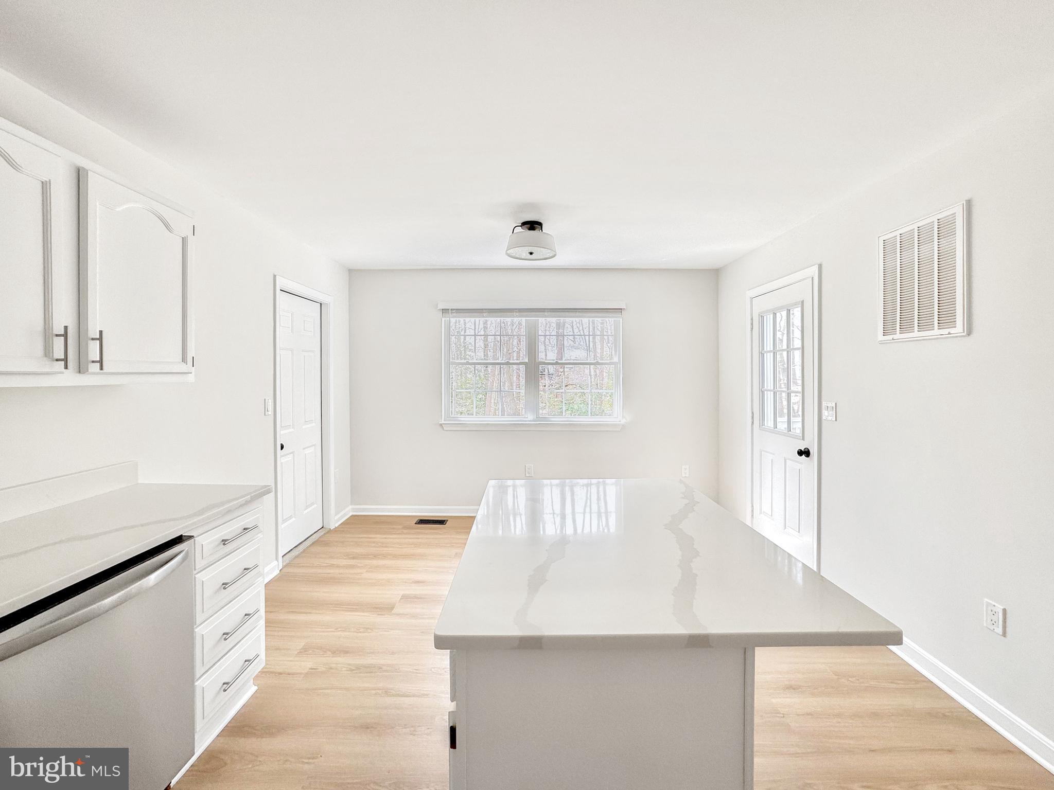 640 Santa Fe Trail Lusby, MD 20657 - Photo 9 of 32 a view of an empty room with wooden floor and a window