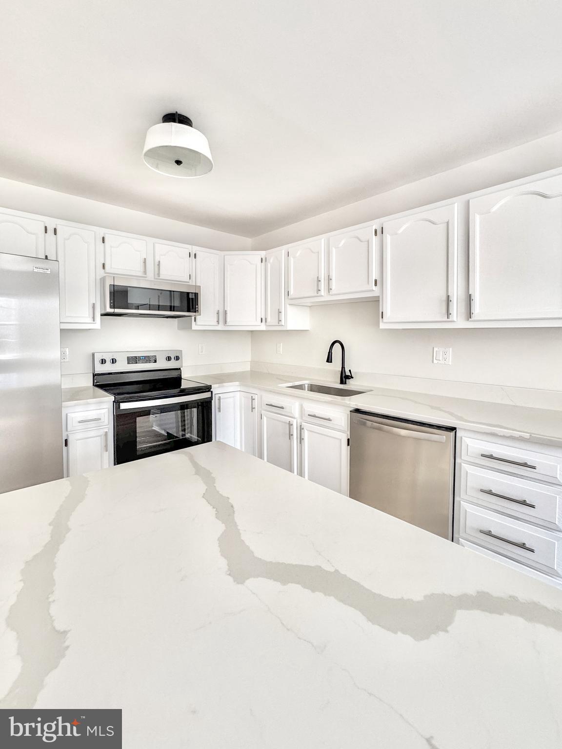 640 Santa Fe Trail Lusby, MD 20657 - Photo 10 of 32 a kitchen with kitchen island a sink stainless steel appliances and cabinets