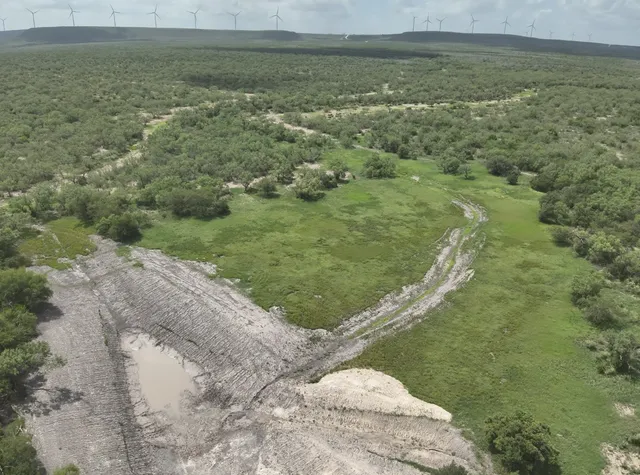 a view of a field with an ocean view