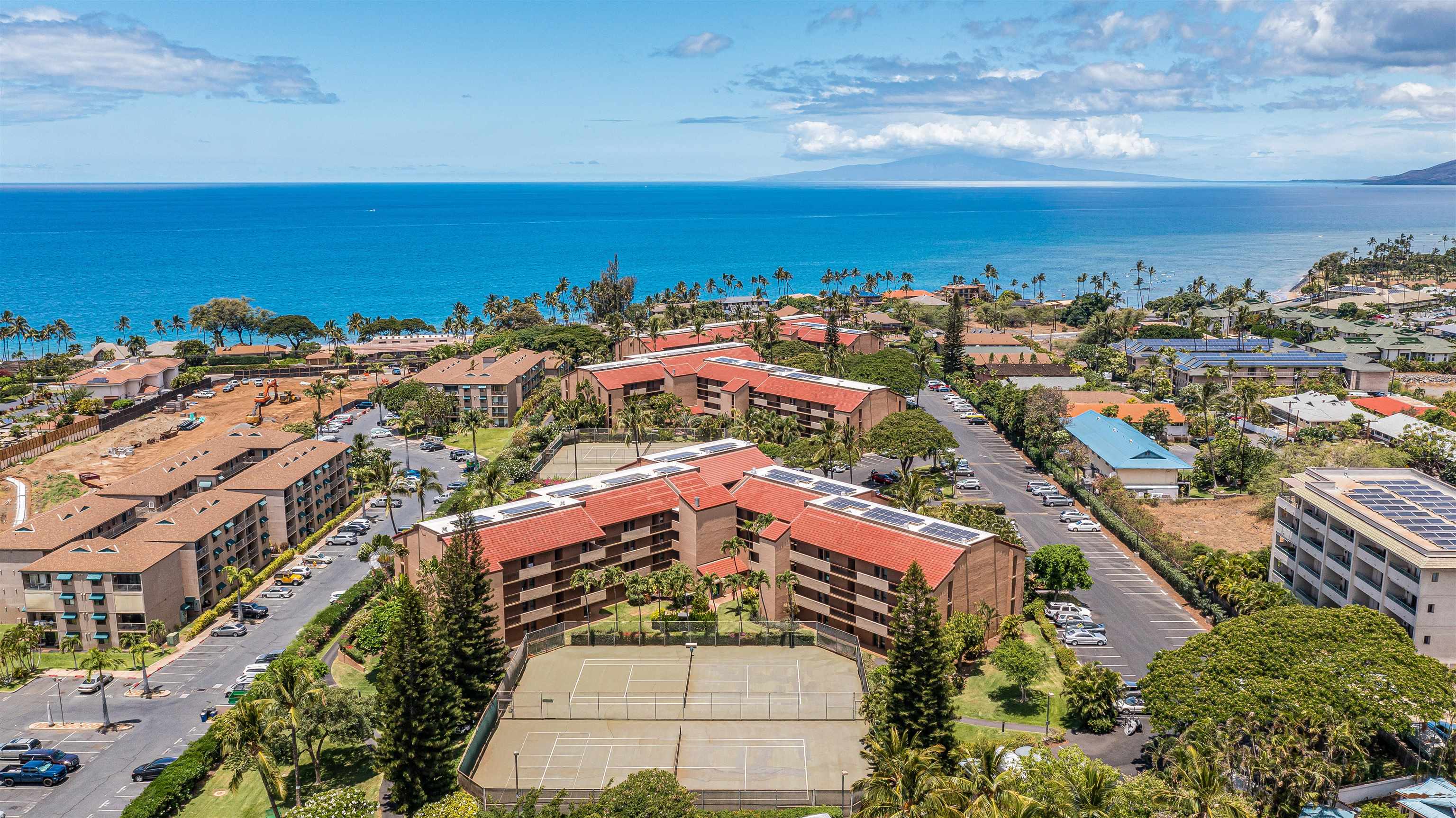 an aerial view of residential building and ocean view