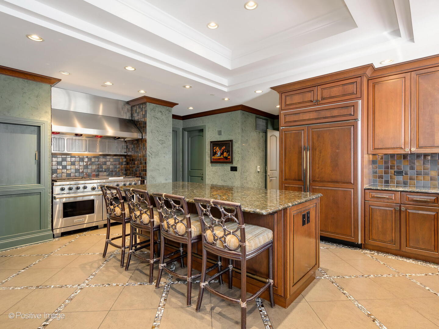 55 West Delaware Place, Unit 1101 Chicago, IL 60610 - Photo 21 of 41 a kitchen with stainless steel appliances kitchen island granite countertop a table and chairs