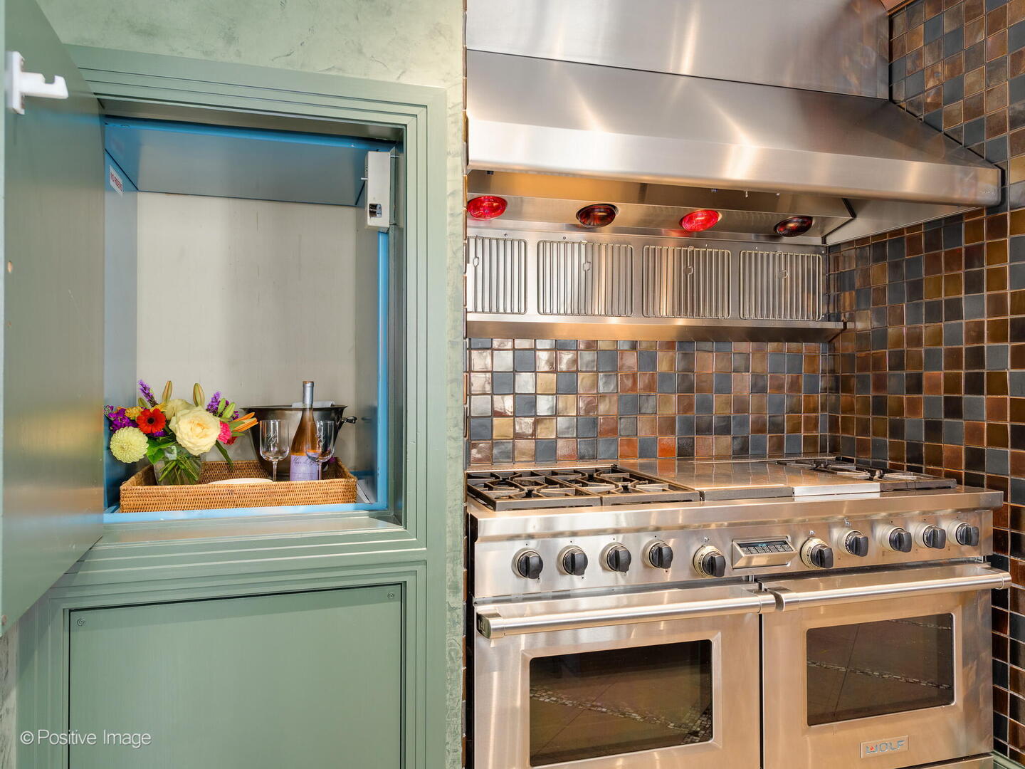 55 West Delaware Place, Unit 1101 Chicago, IL 60610 - Photo 22 of 41 a kitchen with a stove and a white cabinets