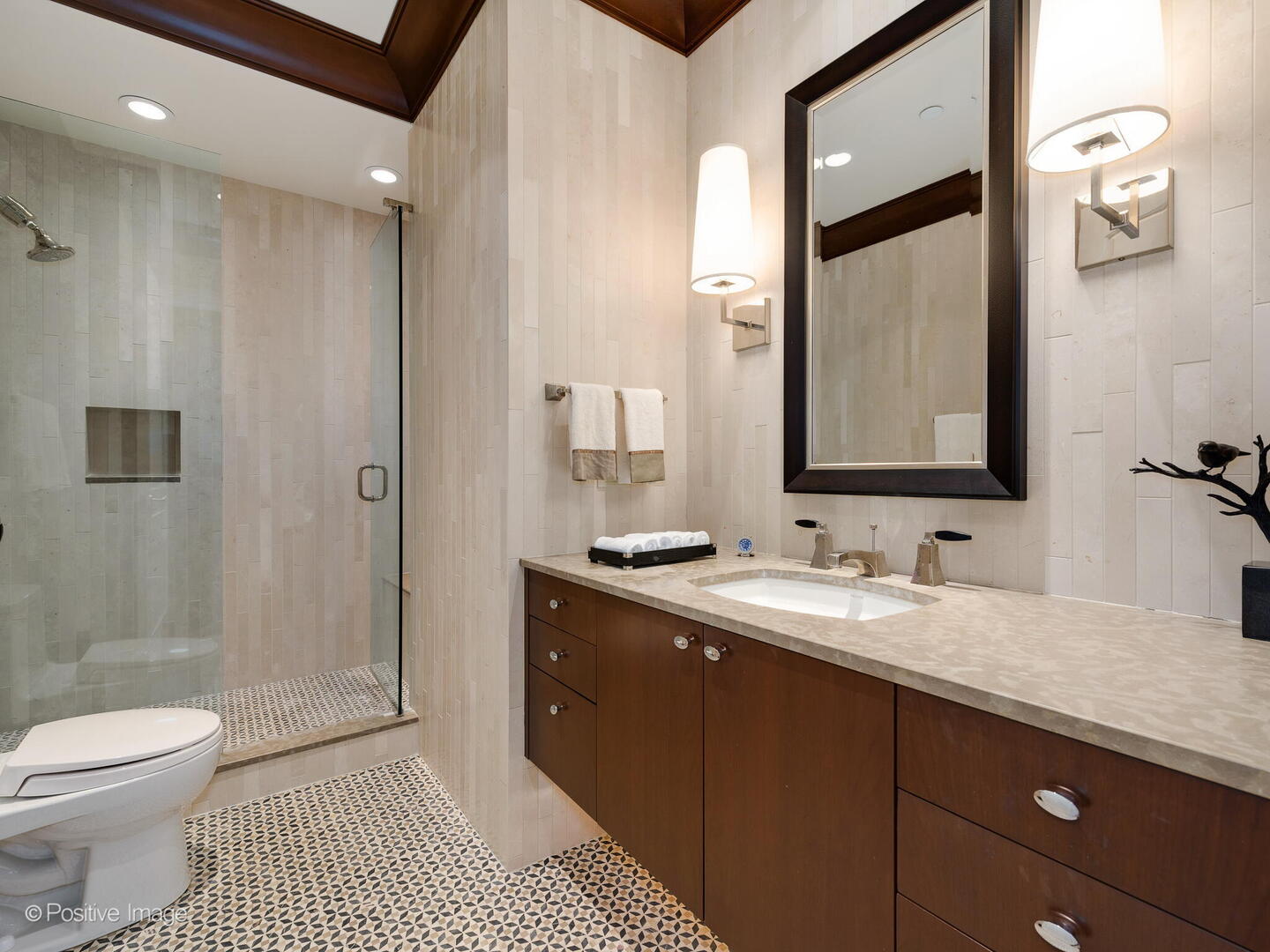 55 West Delaware Place, Unit 1101 Chicago, IL 60610 - Photo 38 of 41 a bathroom with a granite countertop sink a toilet a mirror and shower