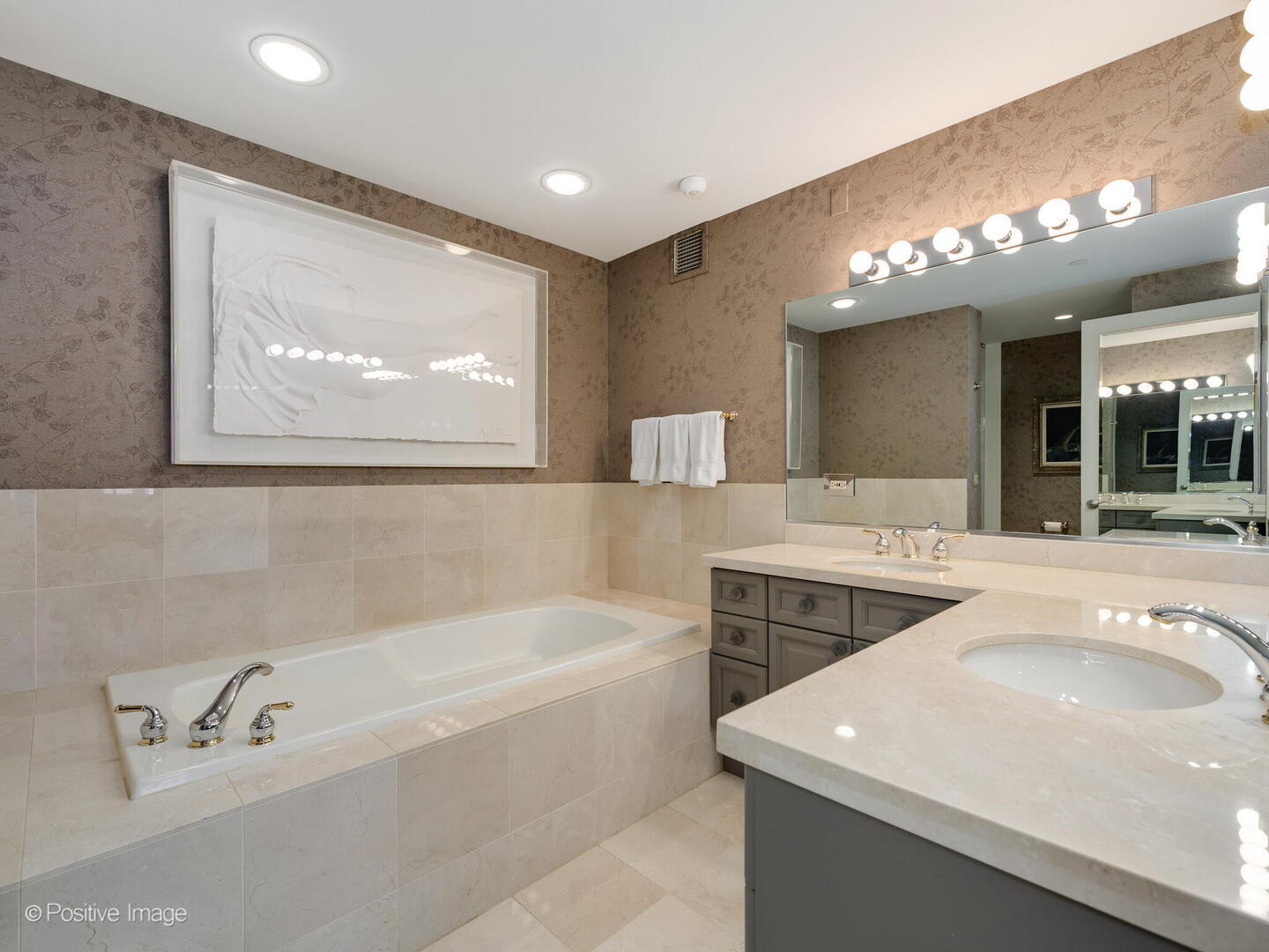 55 West Delaware Place, Unit 1101 Chicago, IL 60610 - Photo 41 of 41 a bathroom with a tub a sink and mirror