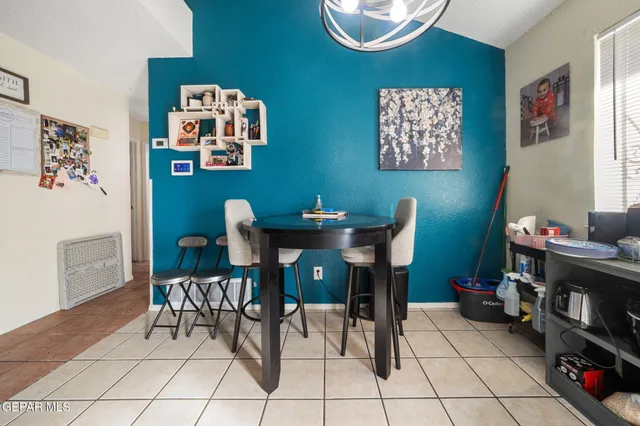 a kitchen with a sink a refrigerator and cabinets