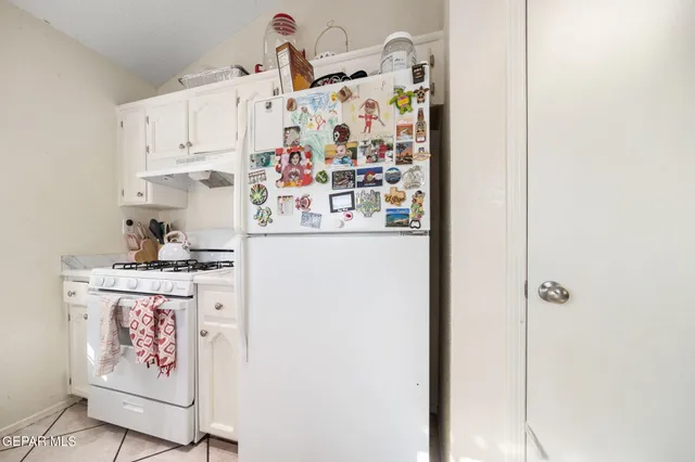 a kitchen with cabinets appliances and a window