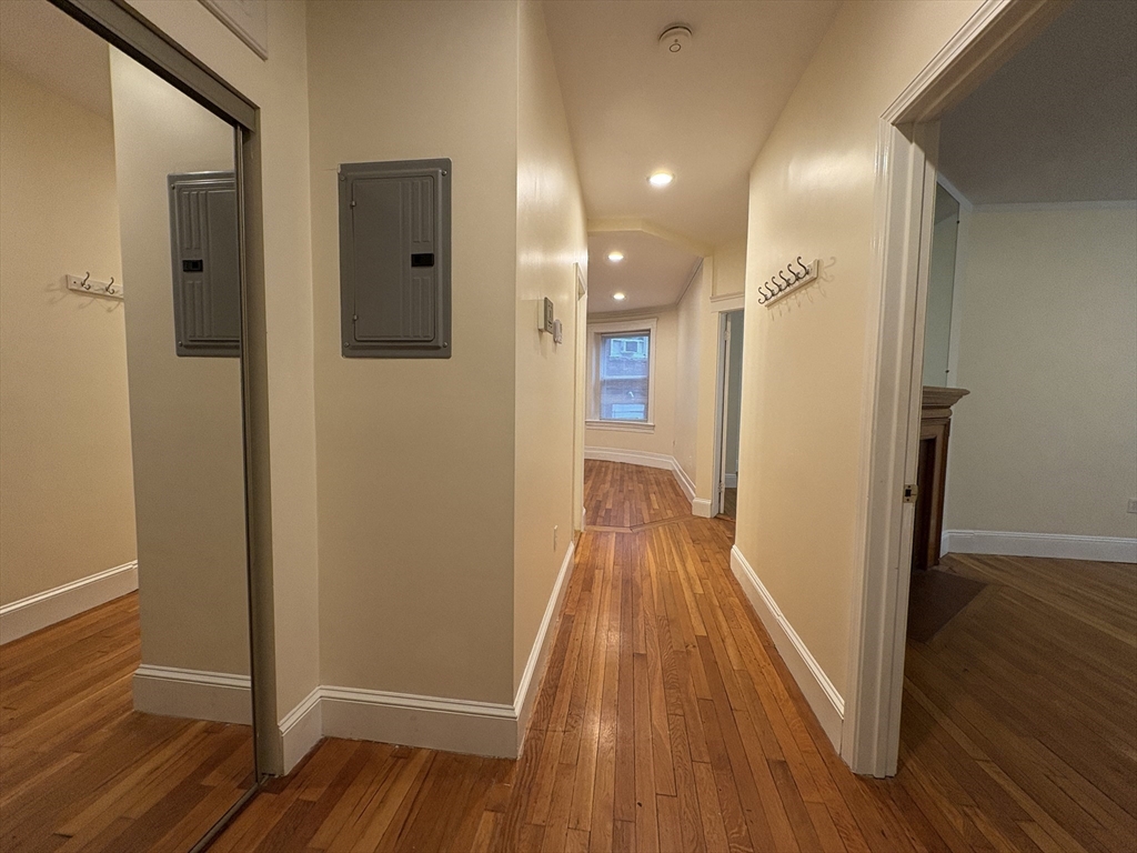 191 Winthrop Road, Unit 1 Brookline, MA 02445 - Photo 8 of 15 a view of a hallway with wooden floor and staircase