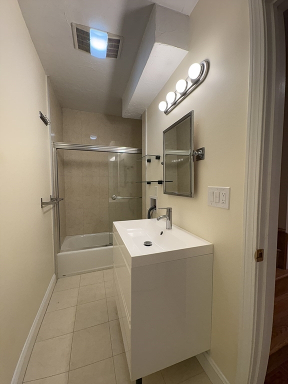 191 Winthrop Road, Unit 1 Brookline, MA 02445 - Photo 10 of 15 a bathroom with a sink a shower and a mirror