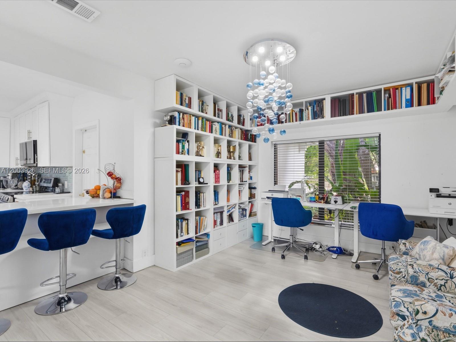 5000 Riviera Drive Coral Gables, FL 33146 - Photo 25 of 80 a workspace with furniture or couch and a bookshelf