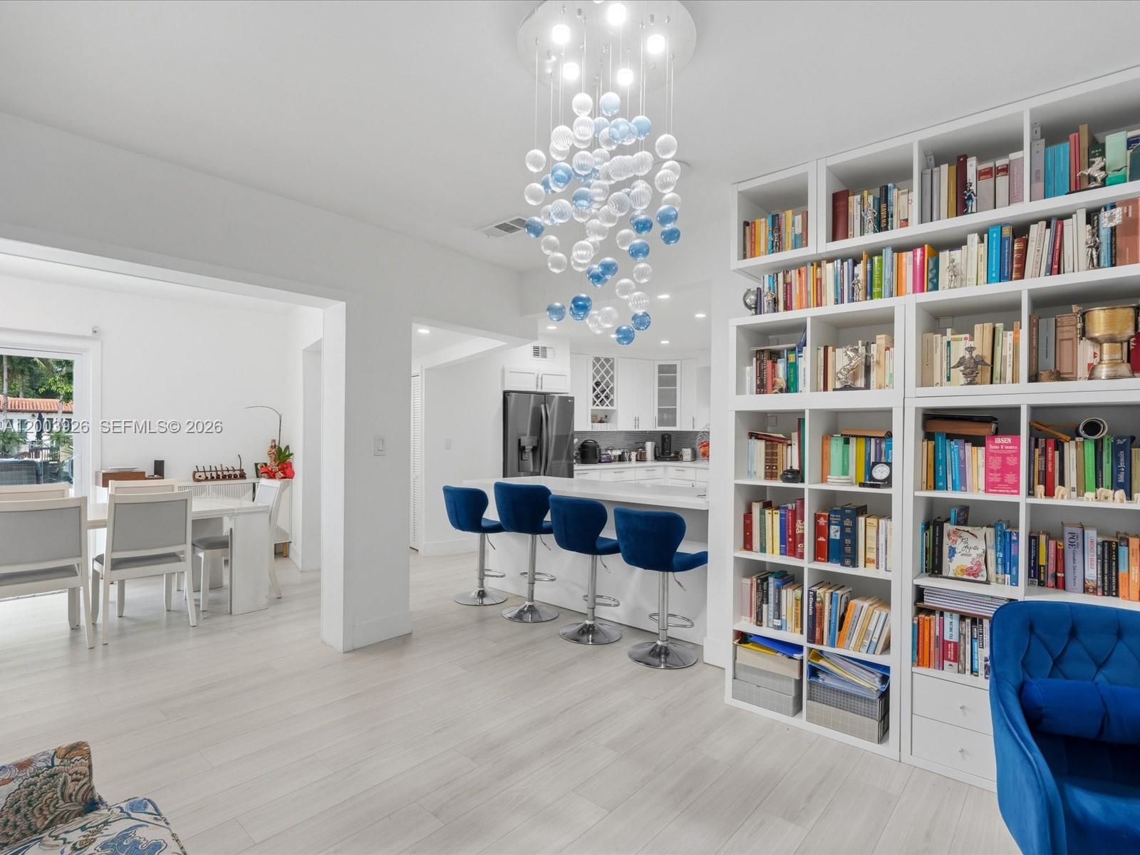 5000 Riviera Drive Coral Gables, FL 33146 - Photo 27 of 80 a living room with furniture and a book shelf